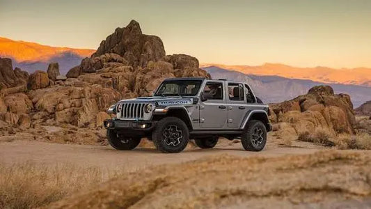 Jeep Wrangler rental in Dubai parked on a desert road at sunset